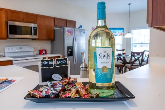 a view of a dining room with furniture a chandelier and wooden floor