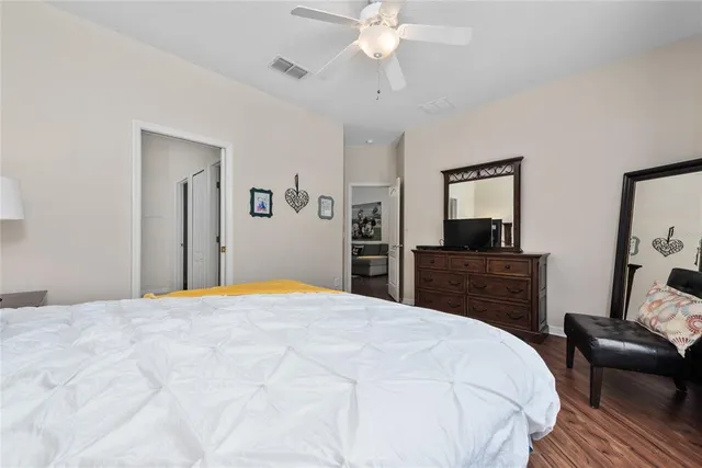 a bedroom with two beds and a lamp