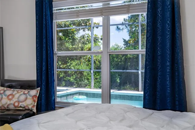 a bedroom with furniture and a window
