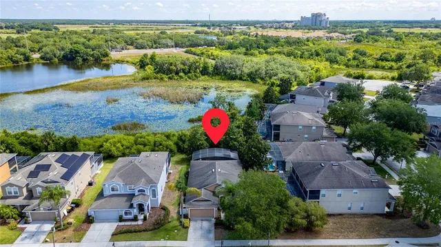 an aerial view of residential houses with outdoor space and swimming pool