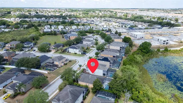 an aerial view of lake and residential houses with outdoor space