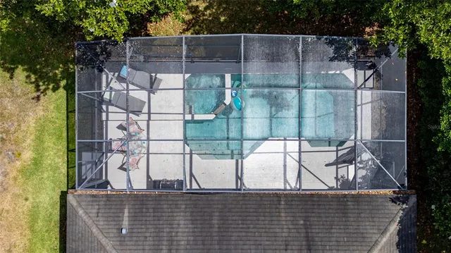 an aerial view of residential houses with outdoor space and swimming pool