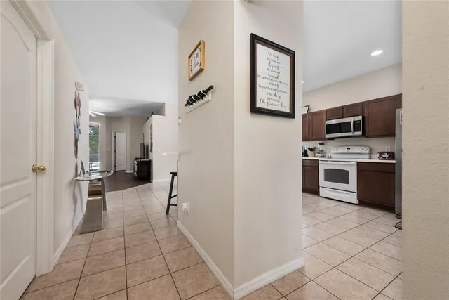 a kitchen with stainless steel appliances kitchen island granite countertop a refrigerator and a sink