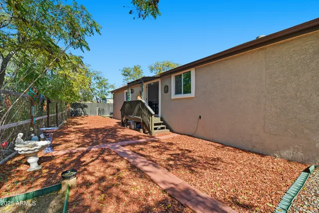a backyard of a house with table and chairs