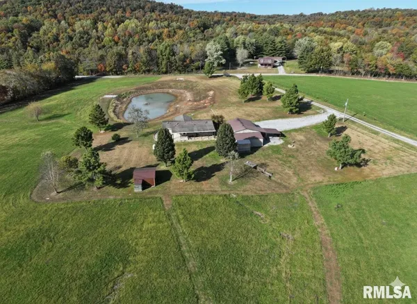 an aerial view of a house with yard
