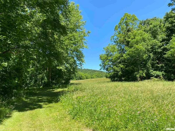a kitchen with a refrigerator a stove and a dining table