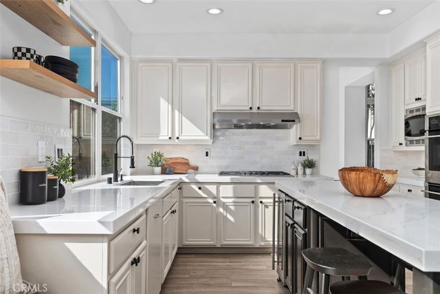 a kitchen with a table chairs stove and cabinets