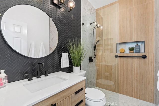 a bedroom with a large bed and a fireplace