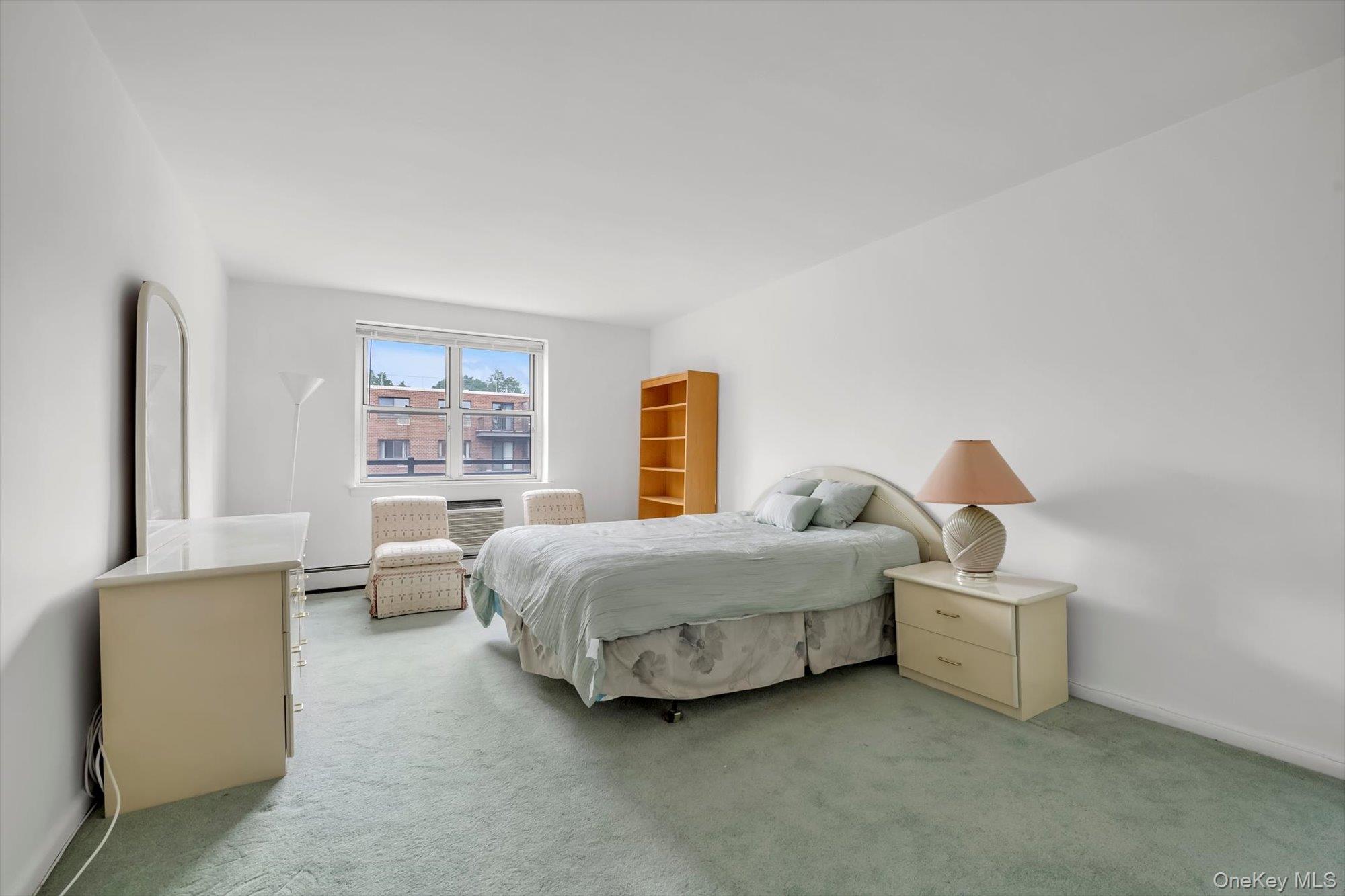 25 Chapel Place, Unit 3N Great Neck, NY 11021 - Photo 13 of 23 a bedroom with bed and window