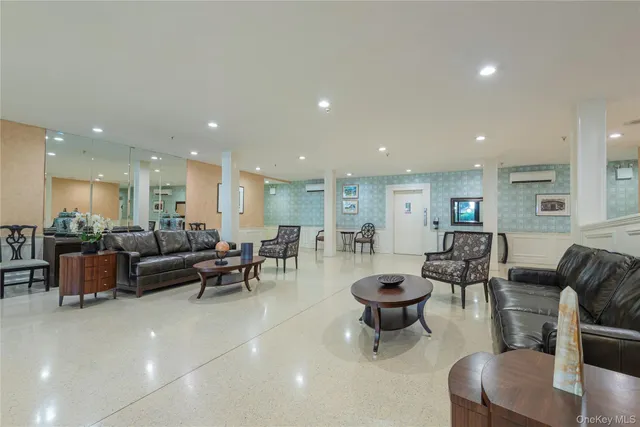 a living room with lots of furniture and a large mirror