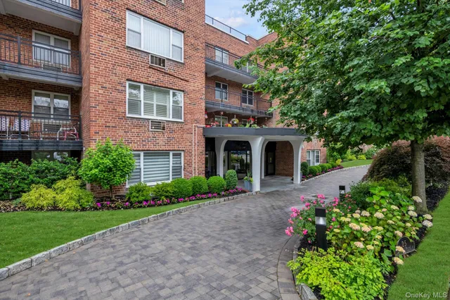 a front view of a house with garden and porch
