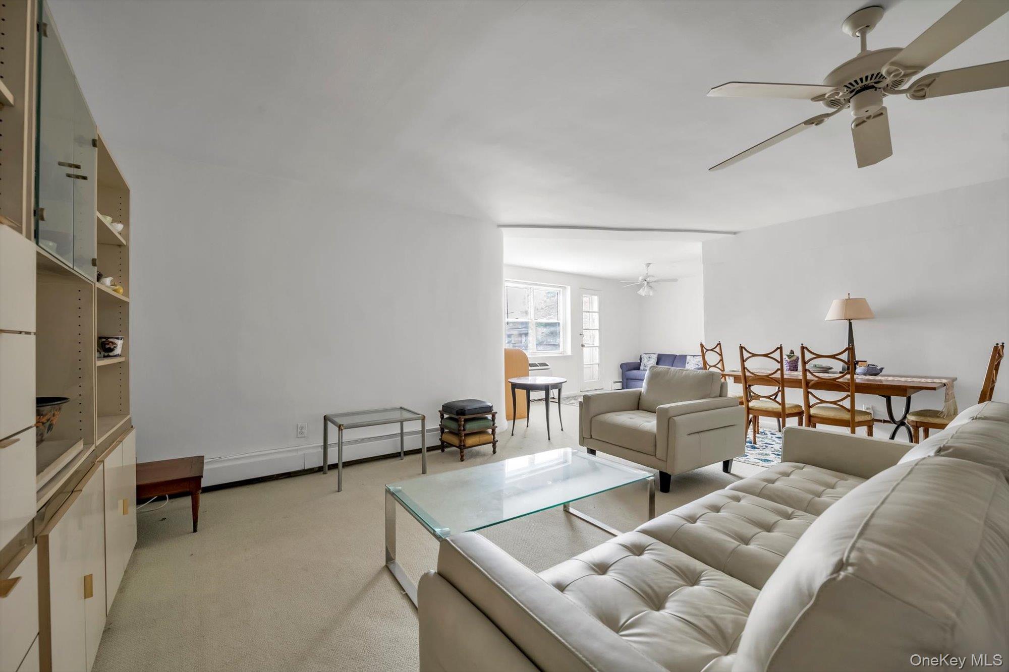 25 Chapel Place, Unit 3N Great Neck, NY 11021 - Photo 5 of 23 a living room with furniture and a flat screen tv