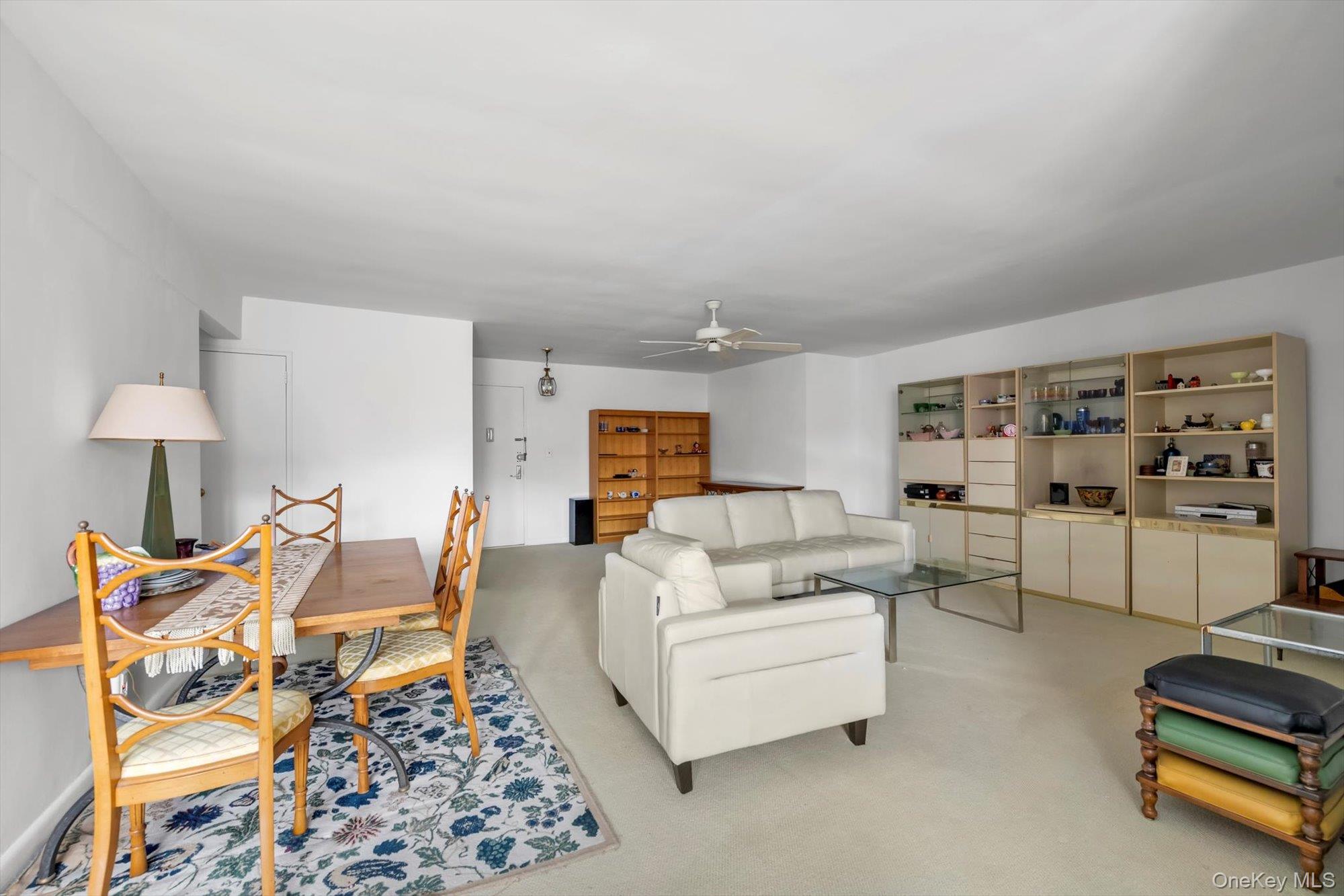 25 Chapel Place, Unit 3N Great Neck, NY 11021 - Photo 8 of 23 a living room with furniture and a table