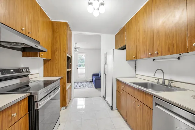 a kitchen with a sink stove and cabinets