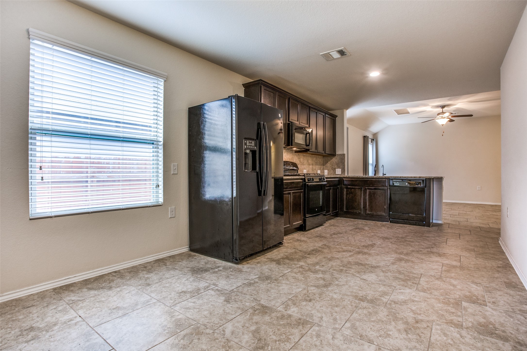 3605 Alpine Autumn Drive Austin, TX 78744 - Photo 12 of 25 a kitchen with stainless steel appliances a refrigerator and a cabinets
