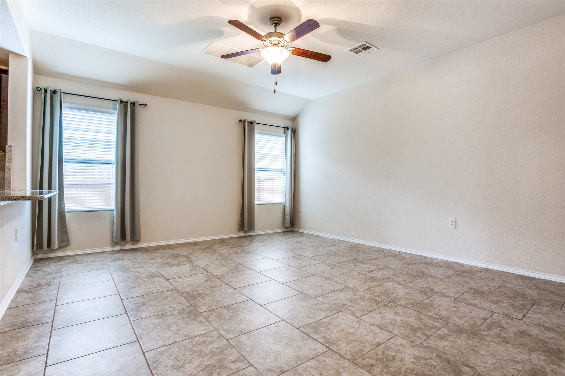 3605 Alpine Autumn Drive Austin, TX 78744 - Photo 5 of 25 a view of a livingroom with a ceiling fan and window