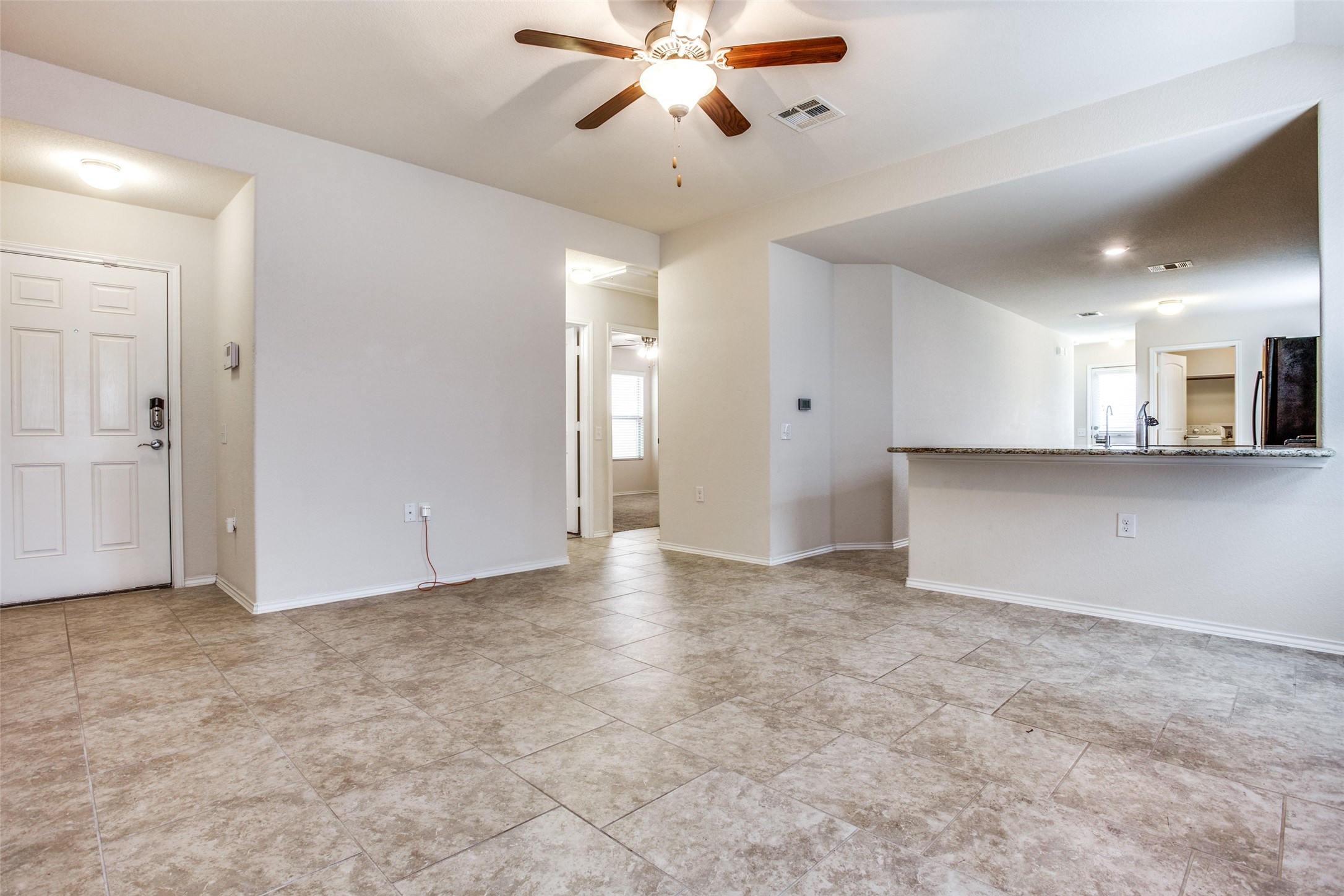 3605 Alpine Autumn Drive Austin, TX 78744 - Photo 7 of 25 a view of a kitchen with a sink and a chandelier fan