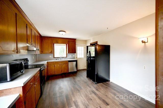 4164 Koala Circle Tega Cay, SC 29708 - Photo 6 of 23 a kitchen with stainless steel appliances granite countertop a refrigerator a sink dishwasher a oven with wooden cabinets and floor