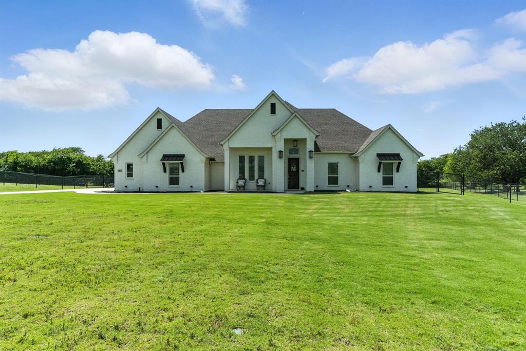 363 Red Bird Drive Springtown, TX 76082 - Photo 11 of 40 a front view of a house with garden
