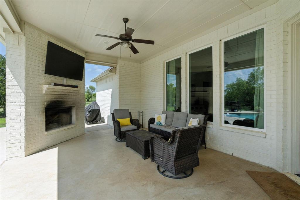 363 Red Bird Drive Springtown, TX 76082 - Photo 13 of 40 a living room with furniture a fireplace and a flat screen tv