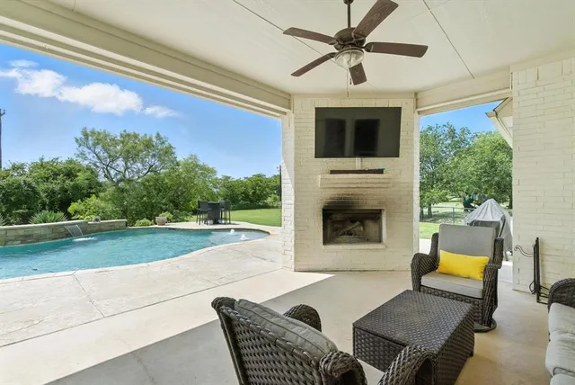 a outdoor living space with furniture and a fireplace
