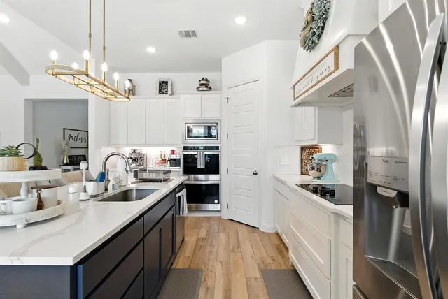 a kitchen with cabinets and stainless steel appliances