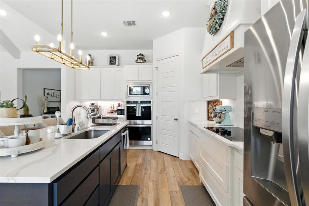 363 Red Bird Drive Springtown, TX 76082 - Photo 17 of 40 a kitchen with cabinets and stainless steel appliances