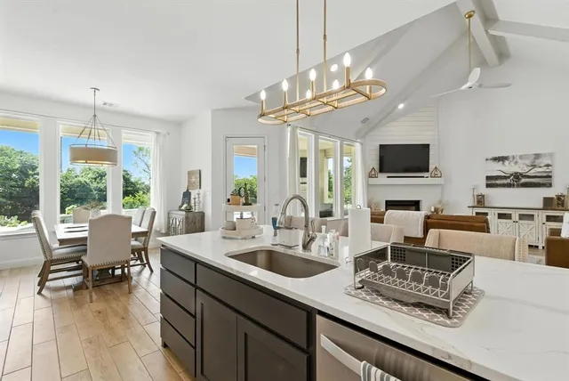 a view of a dining room with furniture a chandelier and wooden floor