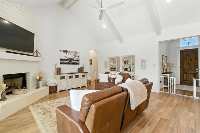 a living room with furniture fireplace and flat screen tv