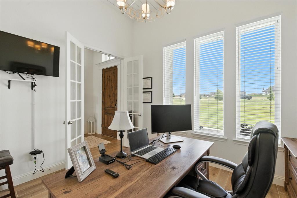 363 Red Bird Drive Springtown, TX 76082 - Photo 31 of 40 a view of a workspace with furniture and a flat screen tv