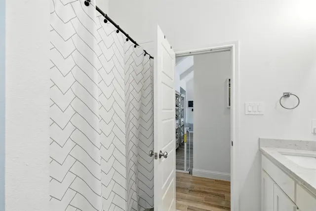 a bathroom with a shower and a sink