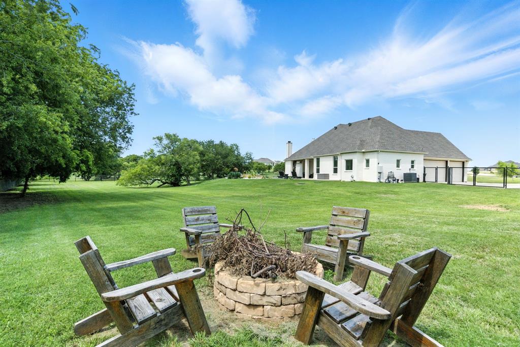 363 Red Bird Drive Springtown, TX 76082 - Photo 6 of 40 a view of a wooden chairs and table in the garden