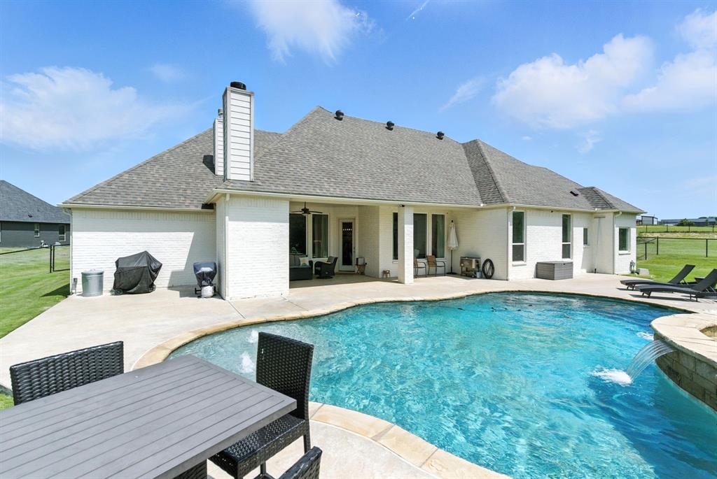 363 Red Bird Drive Springtown, TX 76082 - Photo 7 of 40 a front view of a house with swimming pool having outdoor seating