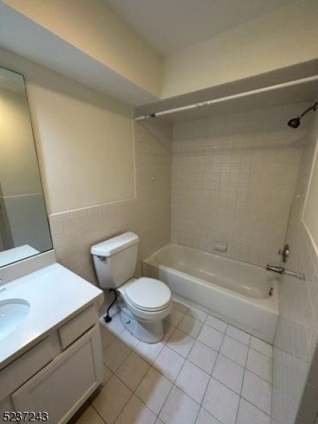 2 Magnolia Court, Unit 2A Madison, NJ 07940 - Photo 13 of 16 a bathroom with a granite countertop sink toilet and shower