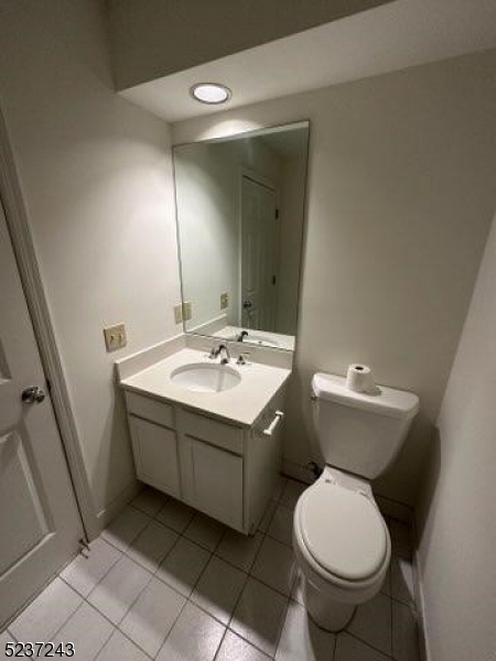 2 Magnolia Court, Unit 2A Madison, NJ 07940 - Photo 14 of 16 a bathroom with a sink toilet and mirror