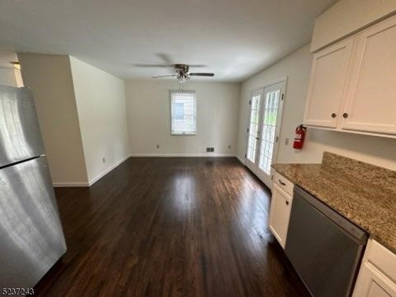 2 Magnolia Court, Unit 2A Madison, NJ 07940 - Photo 2 of 16 a kitchen with granite countertop a stove and wooden floor