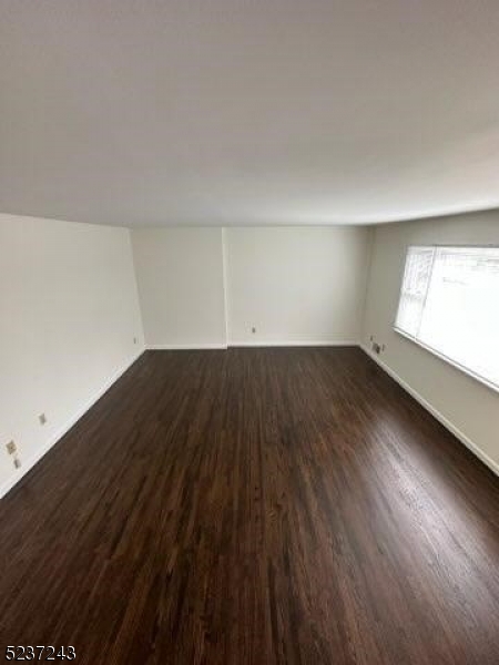 2 Magnolia Court, Unit 2A Madison, NJ 07940 - Photo 4 of 16 an empty room with wooden floor and windows