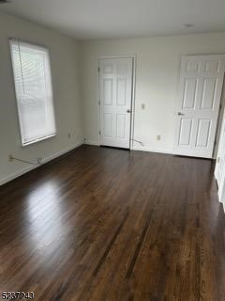 2 Magnolia Court, Unit 2A Madison, NJ 07940 - Photo 6 of 16 an empty room with wooden floor and windows