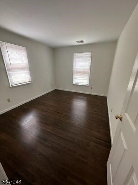 2 Magnolia Court, Unit 2A Madison, NJ 07940 - Photo 8 of 16 an empty room with wooden floor and windows