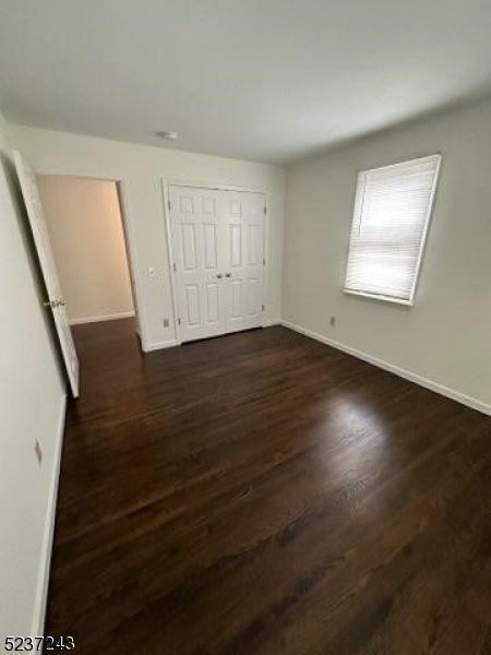 2 Magnolia Court, Unit 2A Madison, NJ 07940 - Photo 9 of 16 an empty room with wooden floor and windows