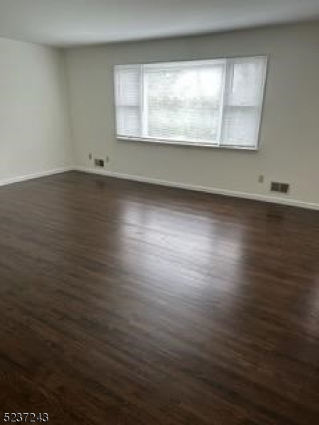 2 Magnolia Court, Unit 2A Madison, NJ 07940 - Photo 10 of 16 an empty room with wooden floor and windows