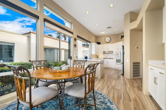 a dining room with furniture and wooden floor