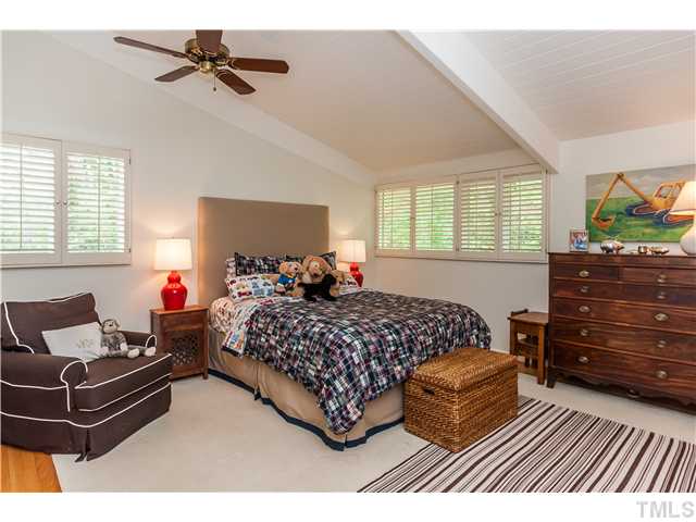 1732 Brooks Avenue Raleigh, NC 27607 - Photo 13 of 24 a bedroom with a bed and wooden floor