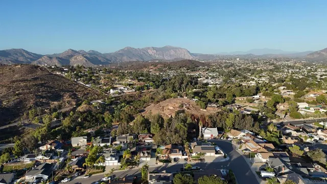 an aerial view of residential house and car parked
