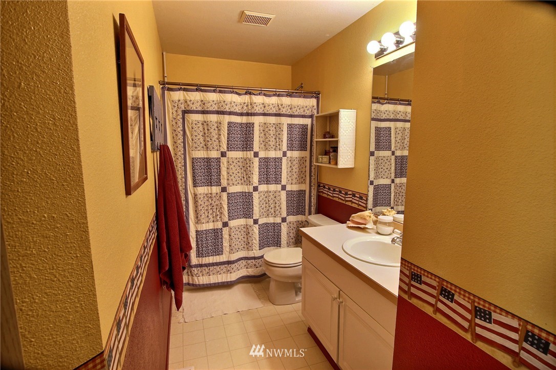 26412 231st Place Southeast Maple Valley, WA 98038 - Photo 11 of 18 a bathroom with a sink a toilet and shower