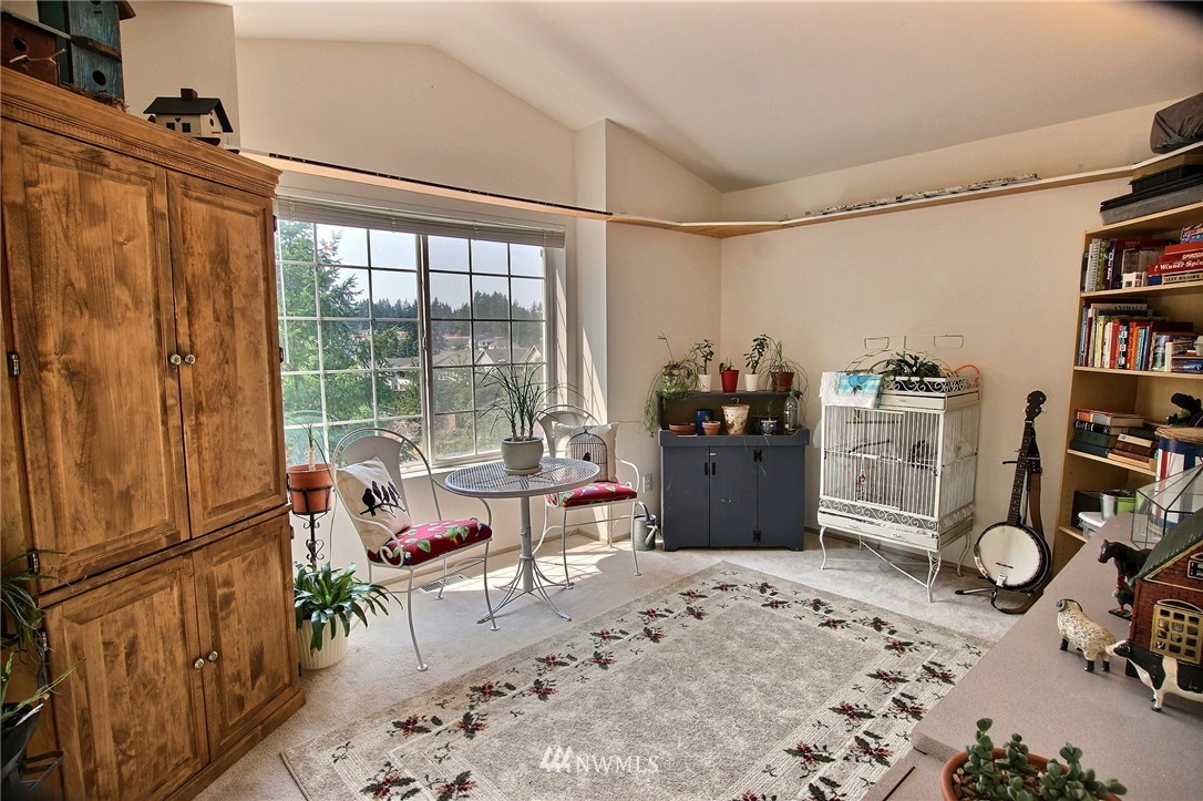 26412 231st Place Southeast Maple Valley, WA 98038 - Photo 14 of 18 a living room with furniture a flat screen tv and a window