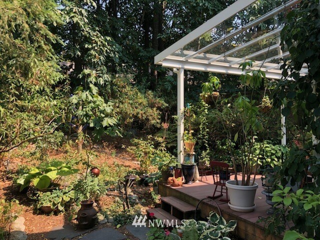26412 231st Place Southeast Maple Valley, WA 98038 - Photo 18 of 18 a view of a porch with furniture and garden