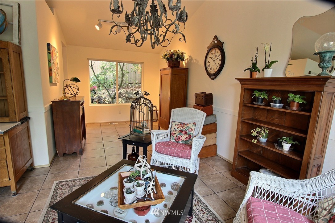 26412 231st Place Southeast Maple Valley, WA 98038 - Photo 3 of 18 a living room with furniture a fireplace a rug and a window