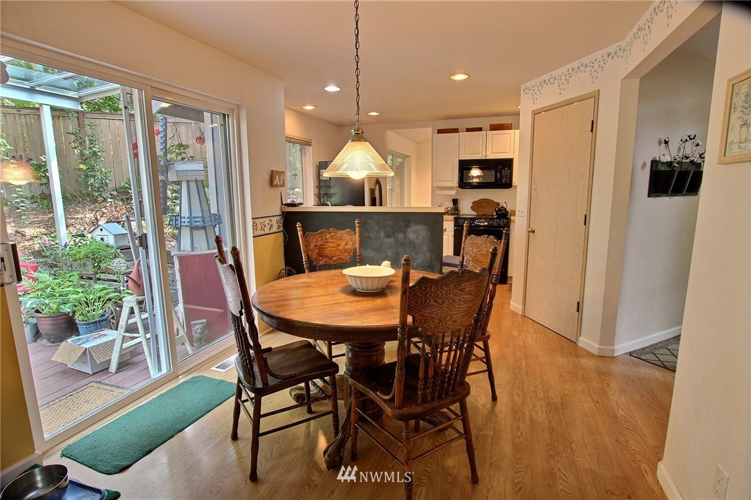26412 231st Place Southeast Maple Valley, WA 98038 - Photo 6 of 18 a view of a dining room and livingroom with furniture wooden floor a chandelier