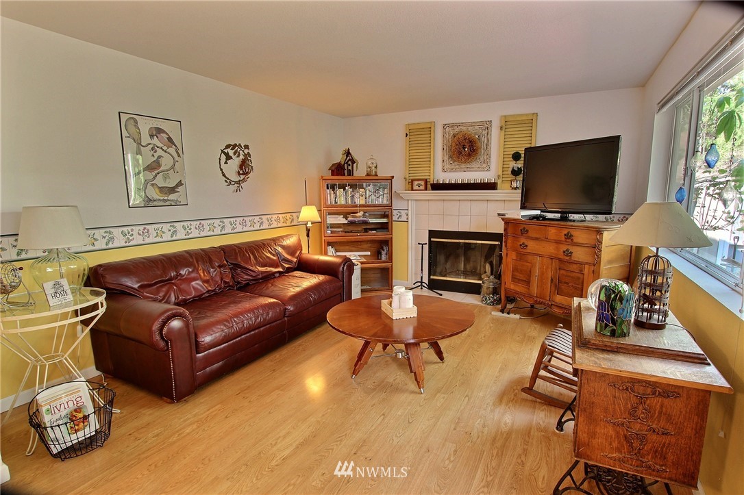 26412 231st Place Southeast Maple Valley, WA 98038 - Photo 7 of 18 a living room with furniture a flat screen tv and a fireplace